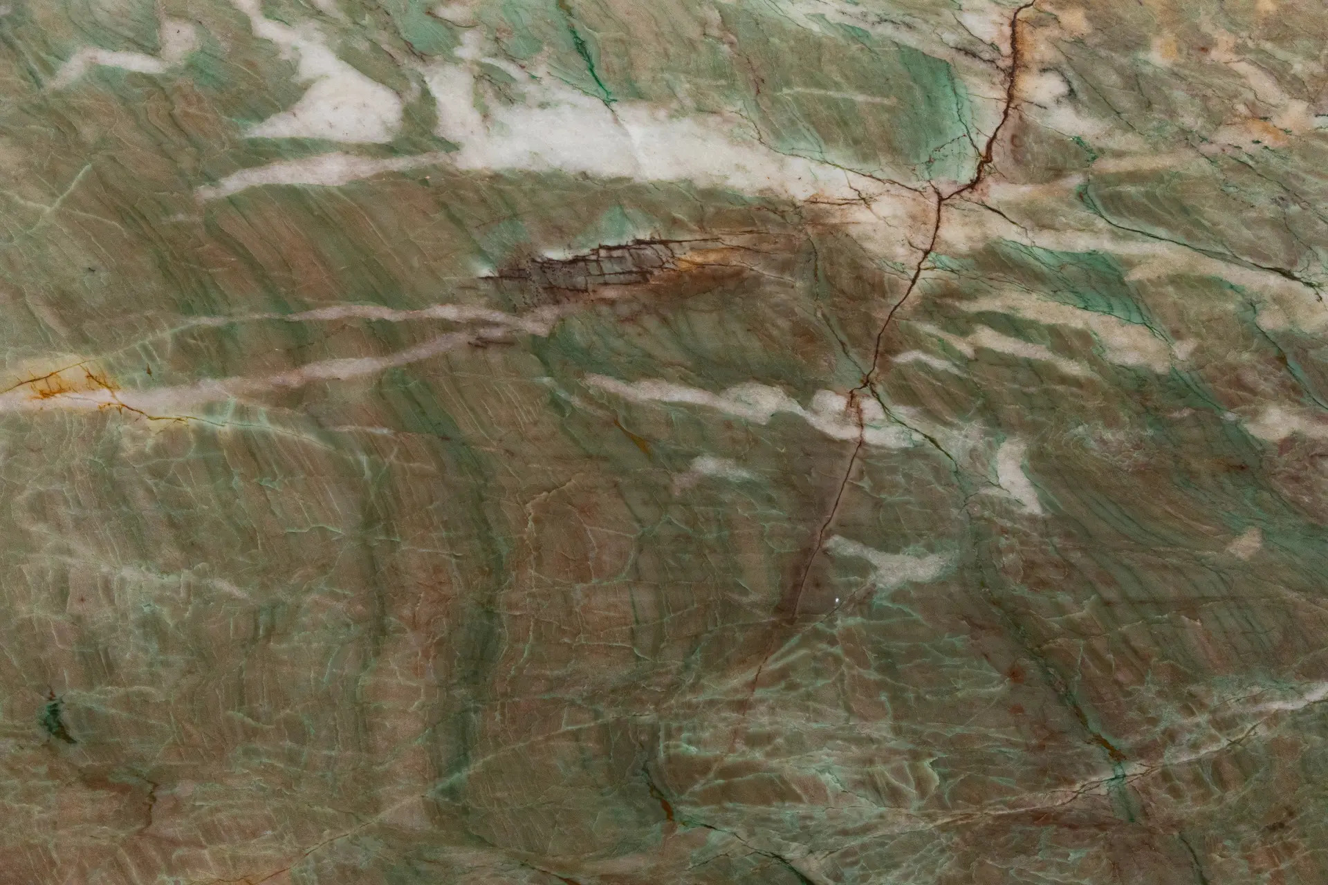 Alexandrita Quartzite slab showcasing rich emerald-green tones with flowing white and amber veining — exotic Brazilian stone for luxury countertops and backlit walls.