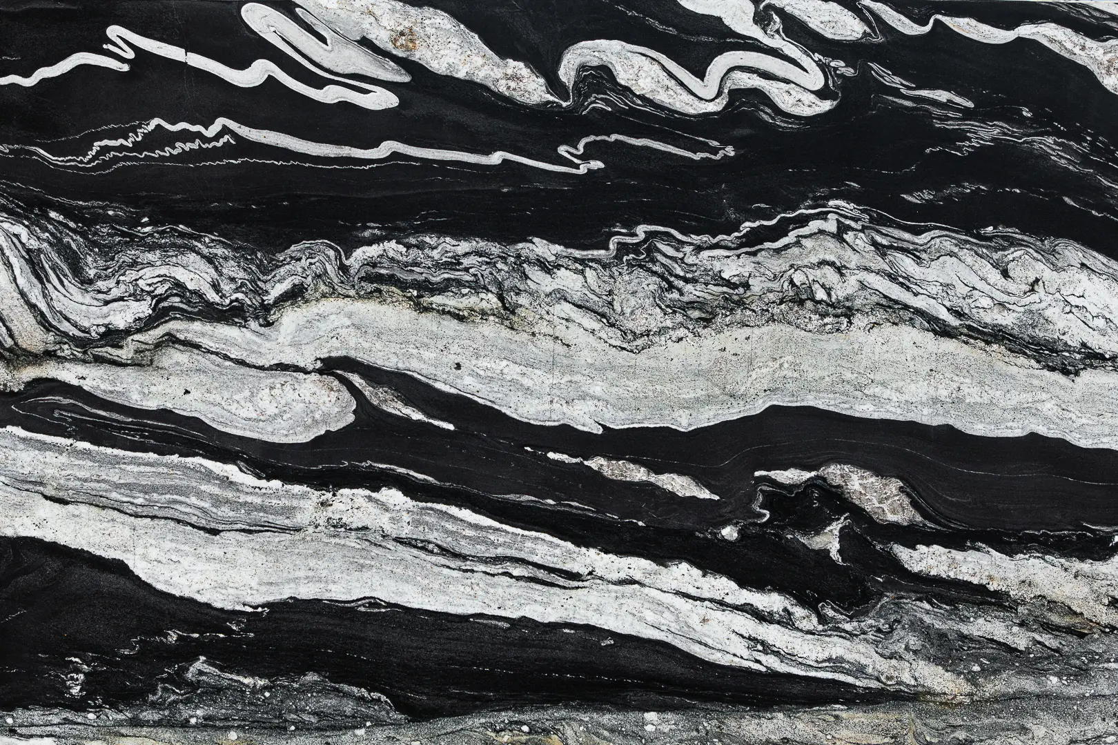Copacabana Granite slab featuring dramatic black and white wave patterns. A Brazilian stone ideal for luxury countertops, kitchen islands, and statement walls.