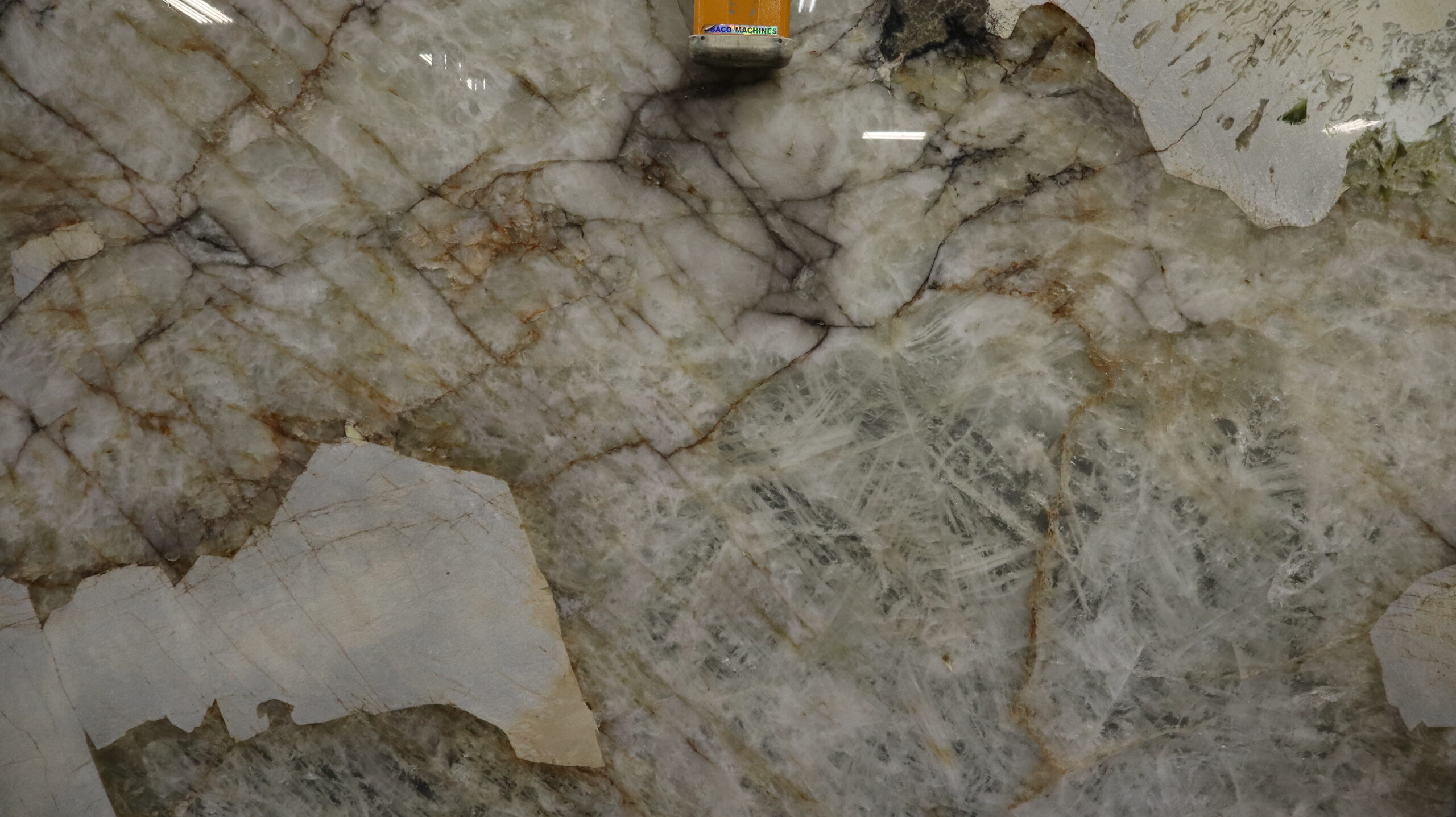 Patagonia Quartzite slab featuring gold, cream, and gray veining with dynamic crystal textures — exotic natural stone for luxury countertops and feature walls.