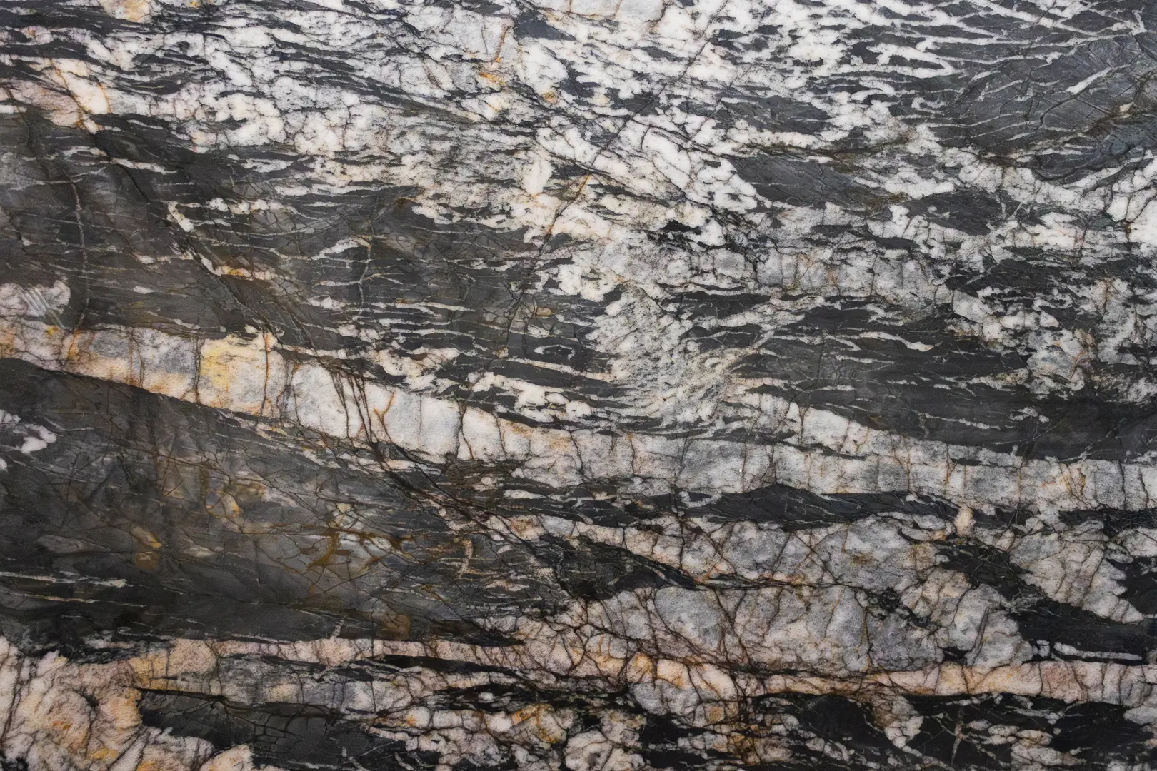Black quartzite slab with streaking white crystals and copper veining found at the Granite Expo las vegas showroom