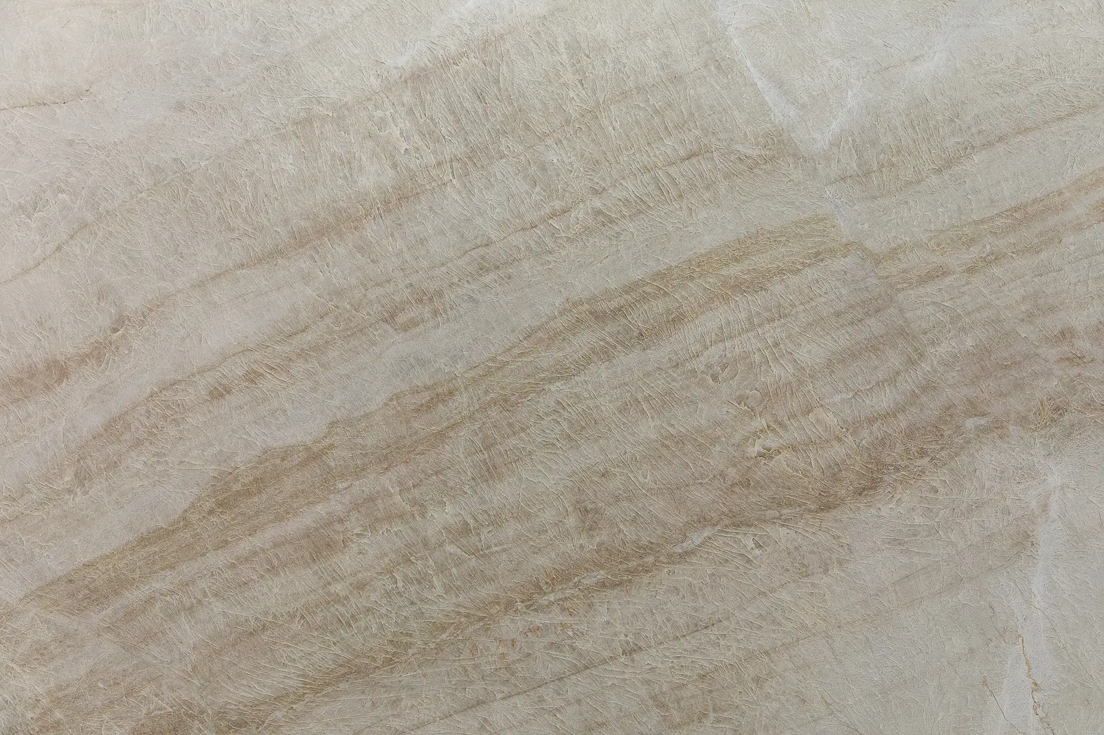 Naica Quartzite slab featuring soft beige tones and warm golden veining. Elegant Brazilian natural stone for luxury countertops and wall applications.