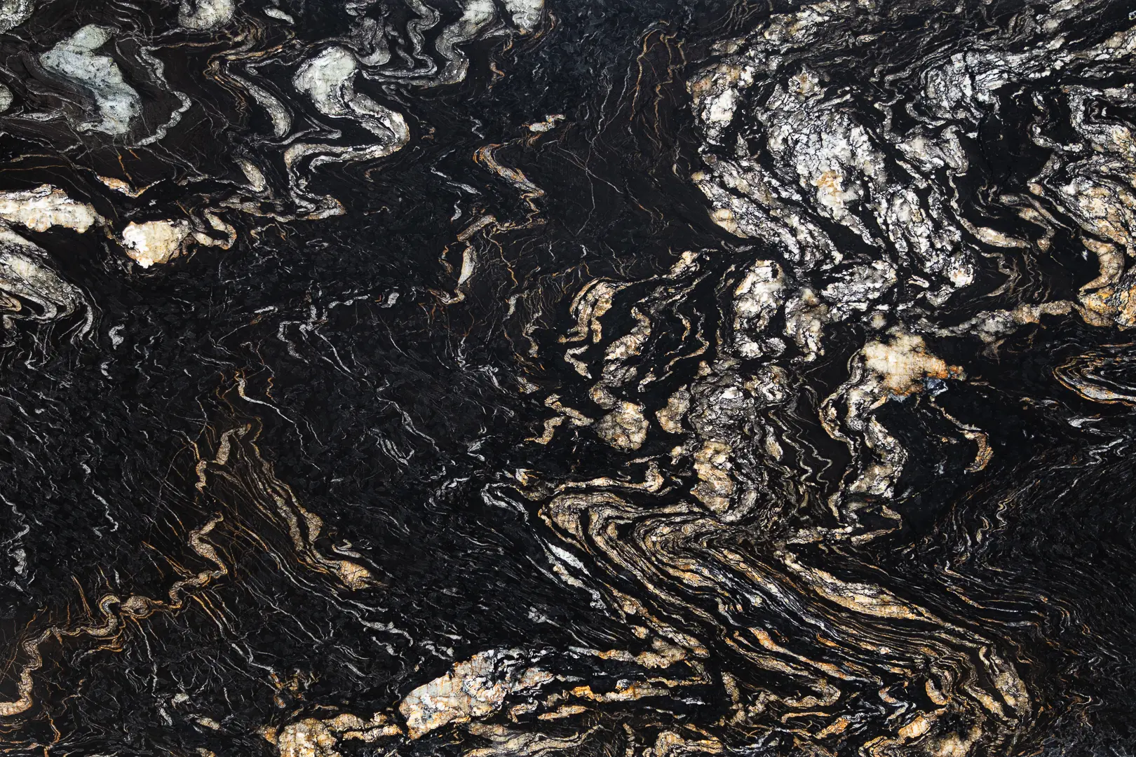 Leathered Titanium Granite slab featuring bold black background with flowing white and gold veining. A Brazilian stone ideal for luxury countertops and statement interiors.