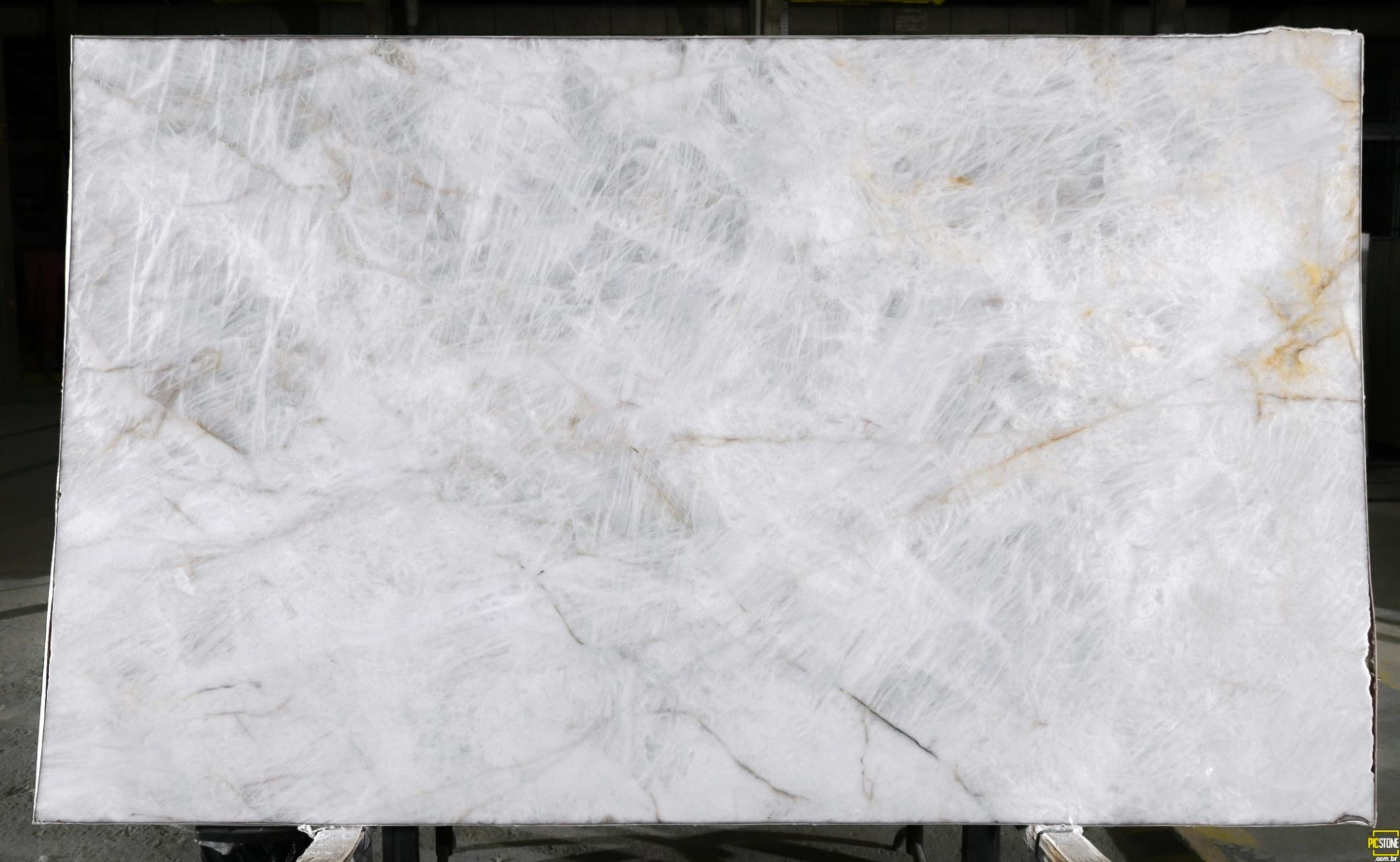 Cristallo Iluminato quartzite slab with translucent white crystal striations and amber threading, polished finish