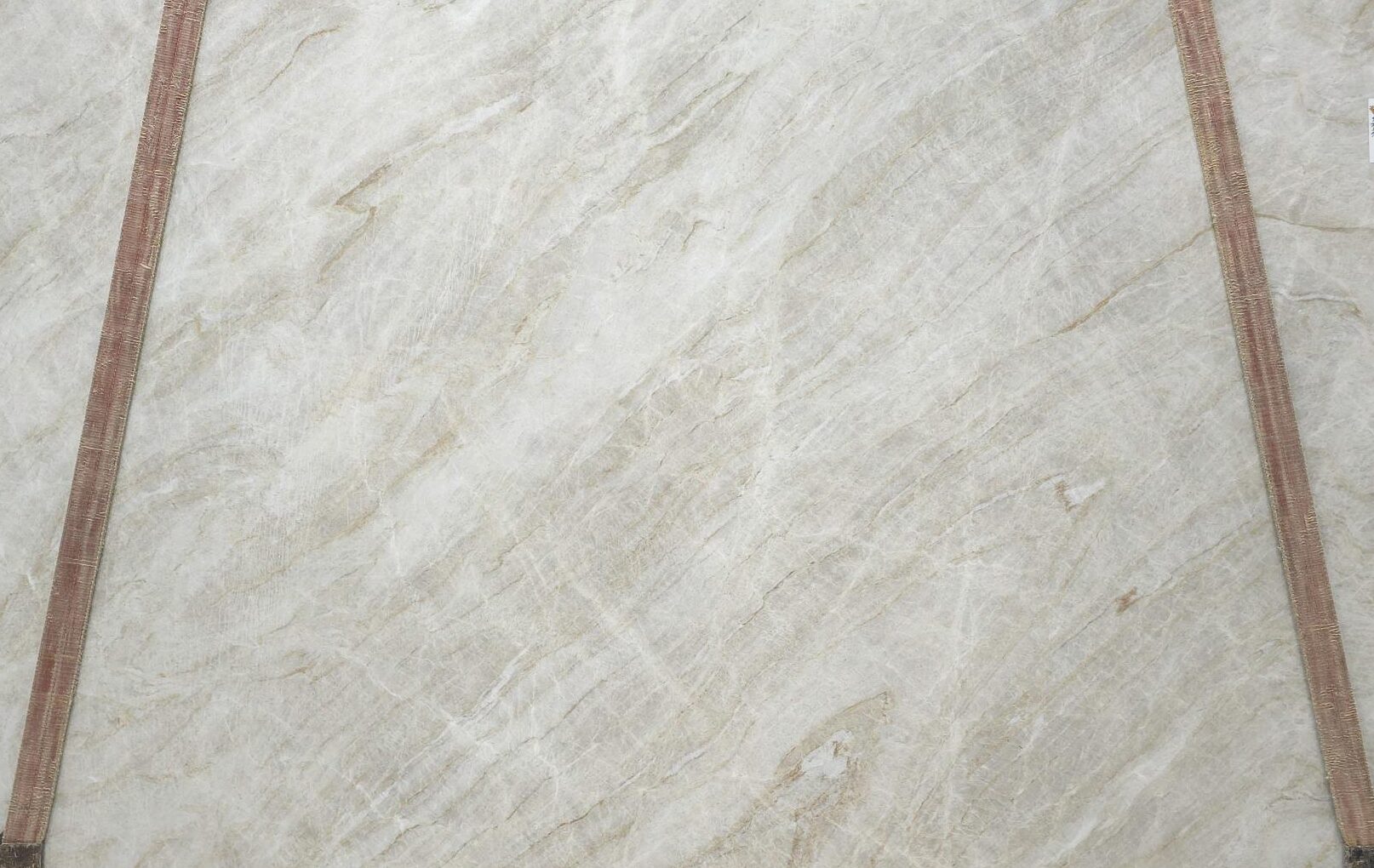 Honed Taj Mahal slabs featuring a soft beige base with golden veining and a smooth matte finish. Elegant natural stone for modern interiors.
